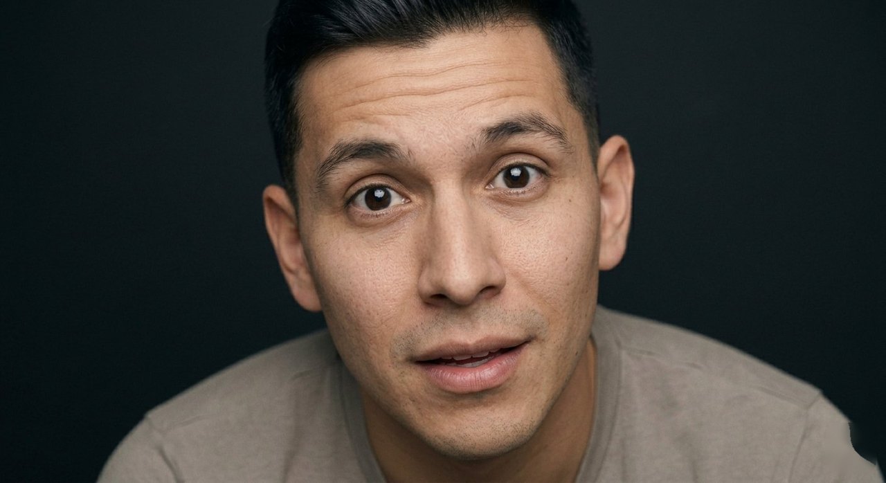 A man's face showing captivation: eyes soft, attention held, a faint smile.