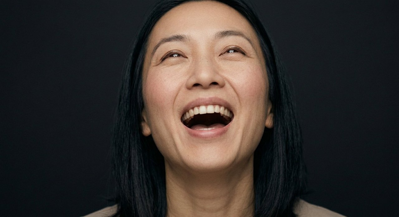 A woman's face showing ecstasy: head tilted up, mouth wide open, eyes nearly shut.