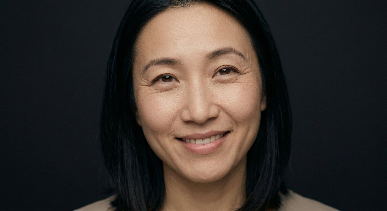 A woman's face showing warmth: a gentle warm smile and soft, kind, tender eyes.