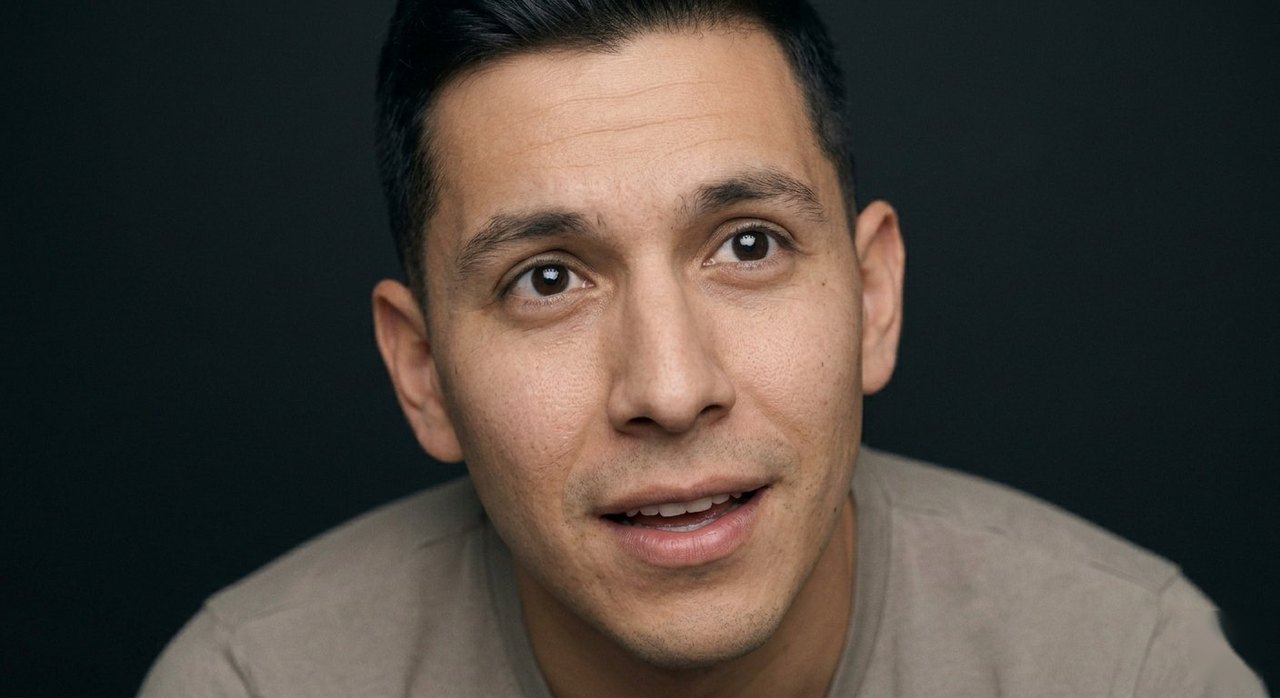A man's face showing wonder: eyes wide, a faint smile of quiet awe.